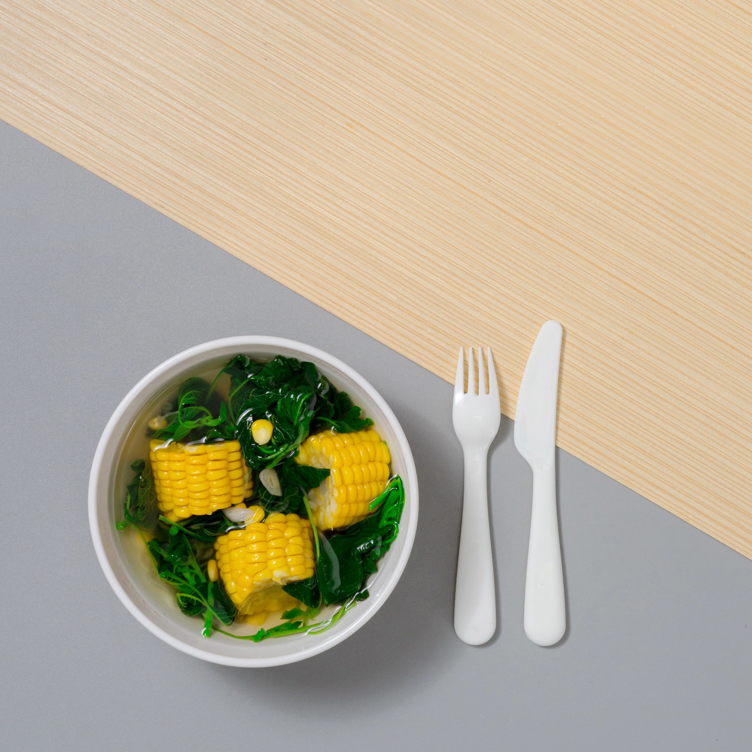 Bowl and cutlery arranged for foodservice
